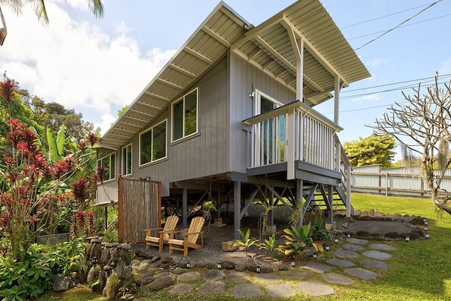 rear view of house featuring fence