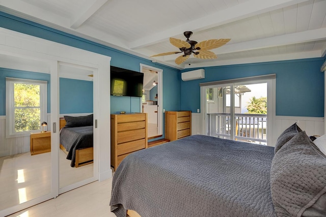 bedroom featuring wainscoting, ceiling fan, access to outside, an AC wall unit, and beam ceiling