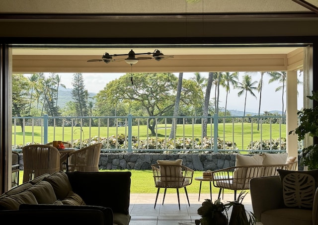 sunroom / solarium featuring a ceiling fan