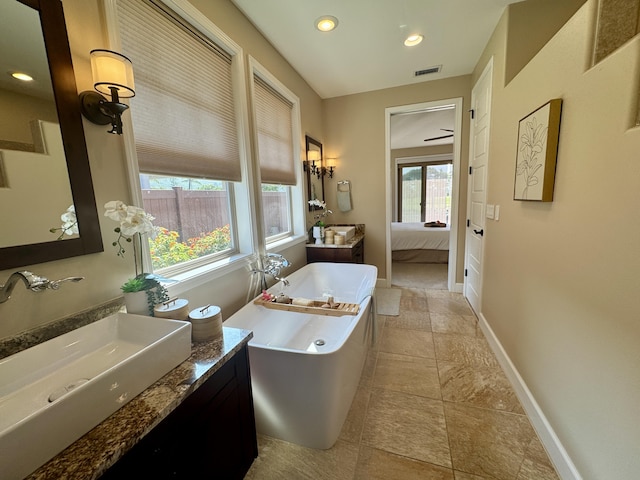 full bath with a freestanding tub, visible vents, ensuite bath, baseboards, and vanity