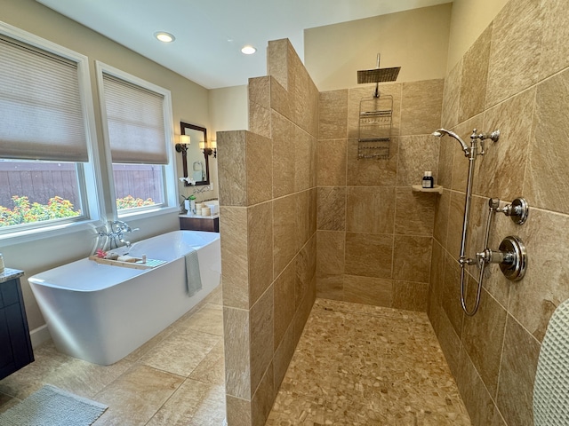 bathroom with a soaking tub, recessed lighting, and a tile shower