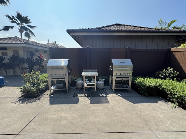 view of patio / terrace featuring fence and a grill