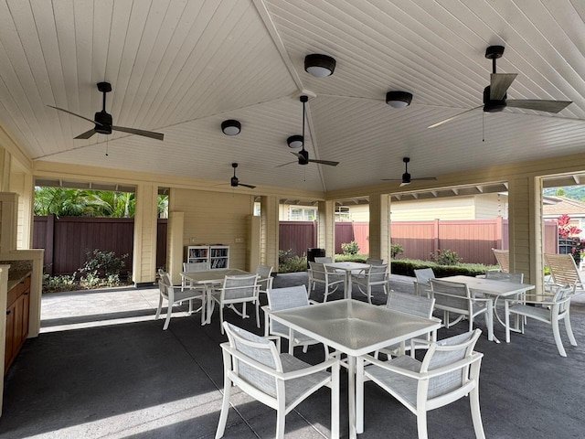 view of patio / terrace with outdoor dining space, a ceiling fan, and fence