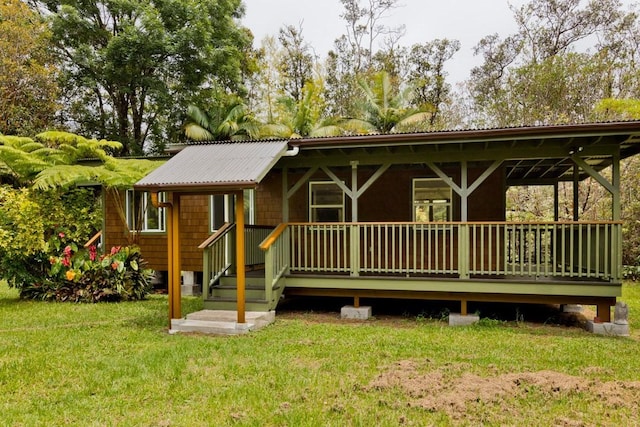 view of front of property with metal roof and a front yard