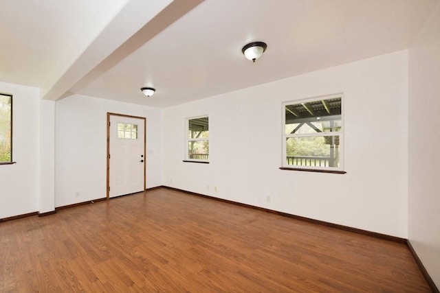 empty room with wood finished floors and baseboards