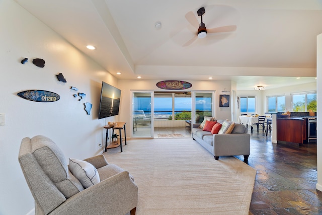 living room featuring ceiling fan, stone tile flooring, and recessed lighting