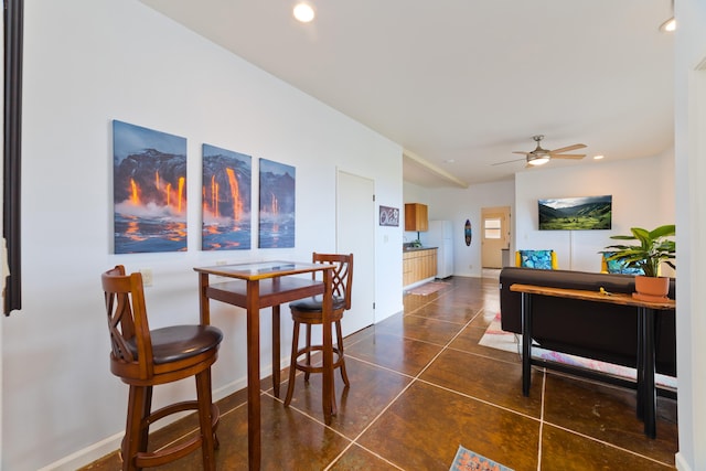 dining area with baseboards, dark tile patterned flooring, a ceiling fan, and recessed lighting