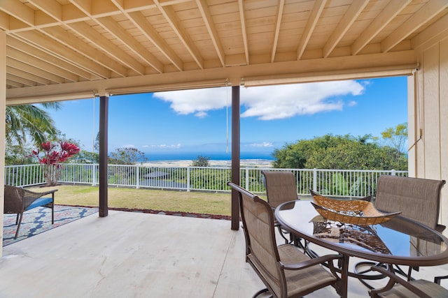 sunroom / solarium featuring beamed ceiling