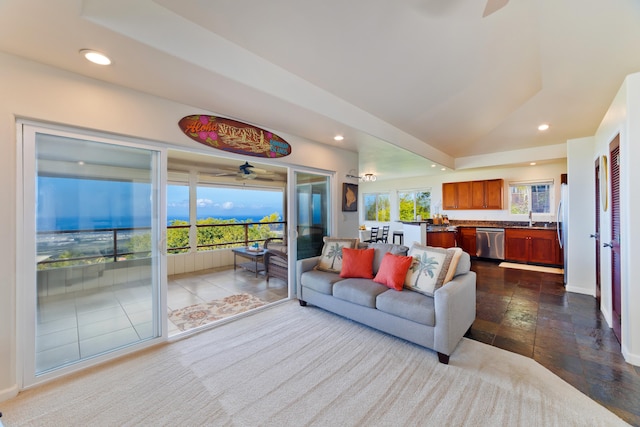 living room featuring lofted ceiling, baseboards, and recessed lighting