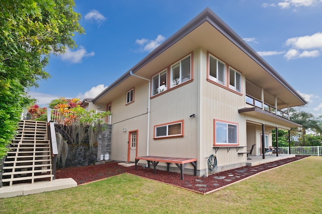 back of house featuring a patio area, stairs, fence, and a yard