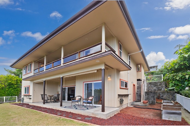 back of house with a patio, a lawn, and fence