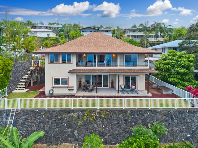 back of property featuring stairs, a patio area, a fenced backyard, and a balcony