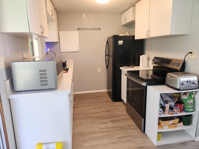 kitchen with a toaster, white cabinetry, light countertops, light wood finished floors, and stainless steel range with electric stovetop