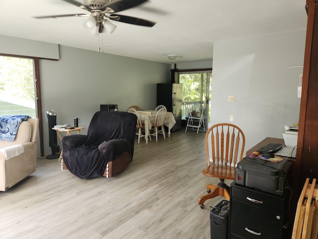 living area with light wood-style floors and ceiling fan