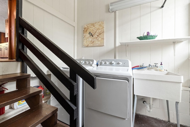 laundry room with laundry area, a sink, and washing machine and clothes dryer