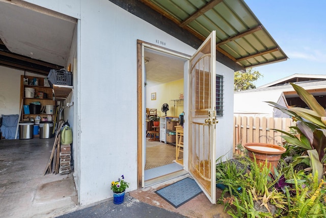 view of exterior entry with fence