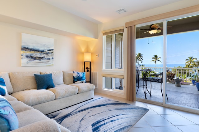 tiled living area featuring visible vents and a ceiling fan