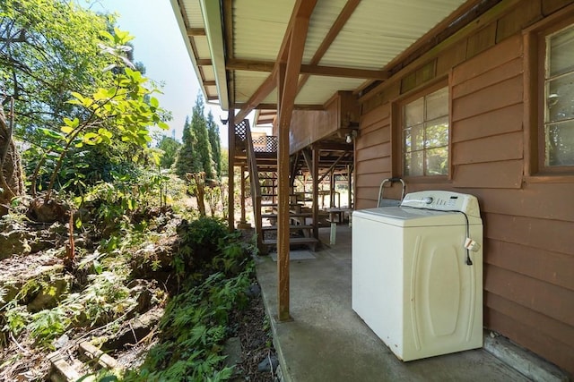 view of patio / terrace featuring stairs and washer / dryer