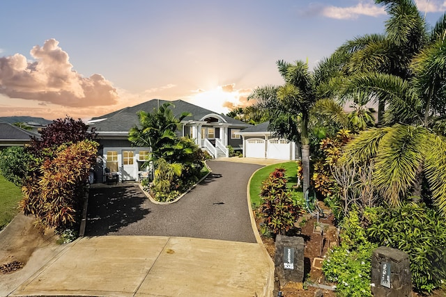 view of front of property with a shingled roof and driveway