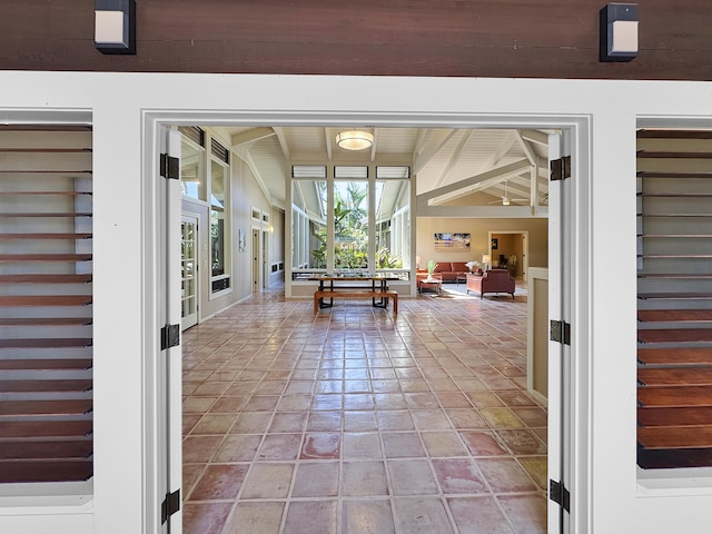 unfurnished sunroom featuring beamed ceiling