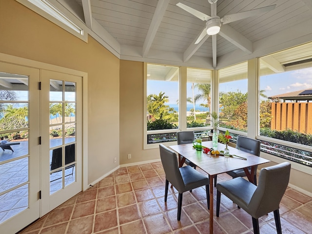 sunroom / solarium featuring beam ceiling and ceiling fan