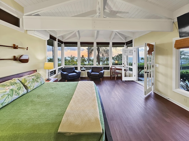 bedroom featuring multiple windows, lofted ceiling with beams, and wood finished floors