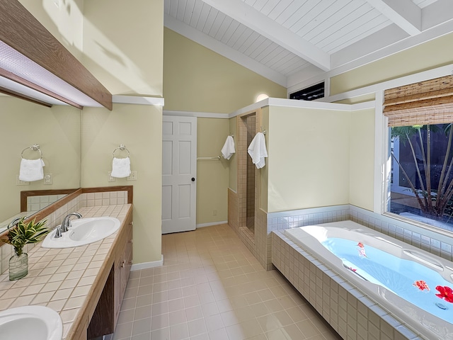 full bath with double vanity, vaulted ceiling with beams, a sink, a shower stall, and a garden tub