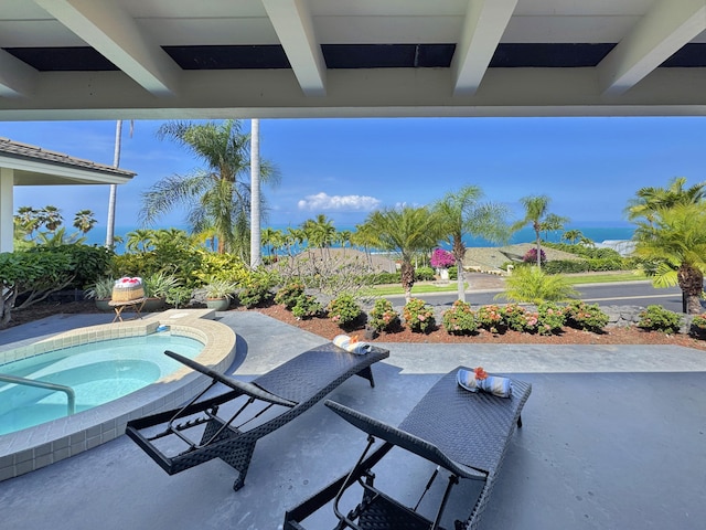 view of patio with an in ground hot tub