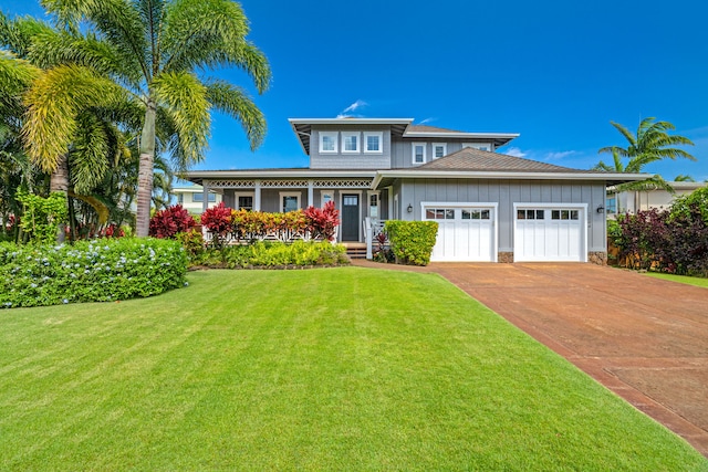 view of front of home featuring a garage, driveway, board and batten siding, and a front yard