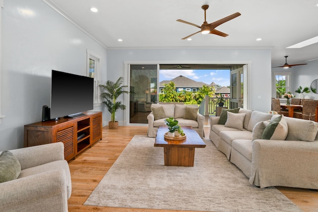 living room featuring light wood-style floors, recessed lighting, crown molding, and ceiling fan