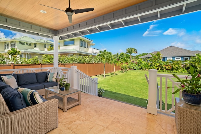 view of patio / terrace with a ceiling fan, fence, and an outdoor living space