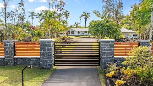 view of gate with fence and central air condition unit