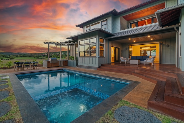 pool at dusk with area for grilling, a patio, outdoor lounge area, and an outdoor pool