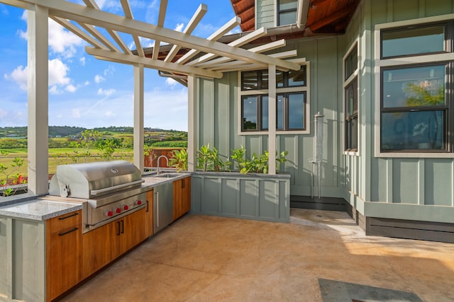 view of patio featuring a grill, an outdoor kitchen, and a pergola