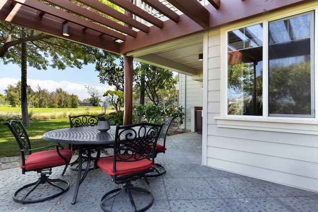 view of patio featuring outdoor dining area and a pergola