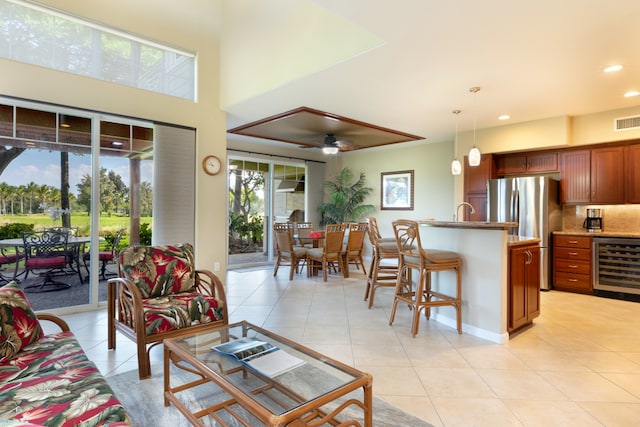 living room with ceiling fan, light tile patterned flooring, recessed lighting, beverage cooler, and visible vents