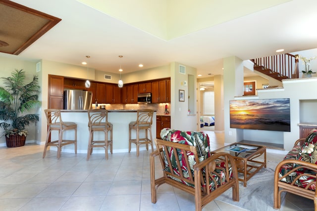 living area with light tile patterned floors, baseboards, visible vents, and recessed lighting