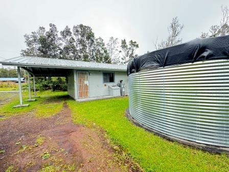 view of outbuilding featuring driveway and an attached carport