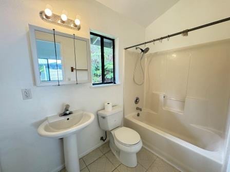 full bathroom with lofted ceiling,  shower combination, toilet, and tile patterned floors