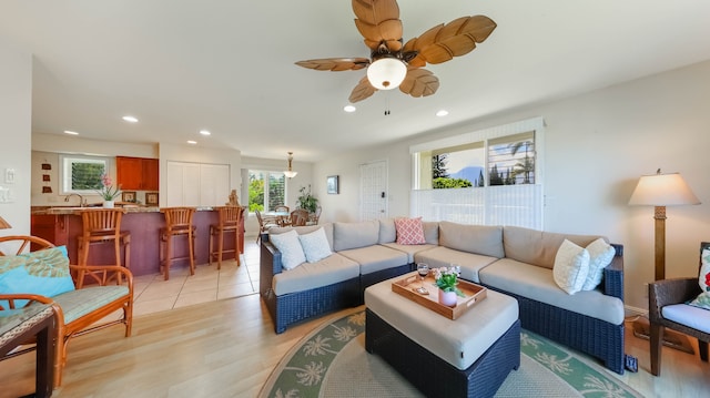 living area featuring ceiling fan, light wood finished floors, and recessed lighting