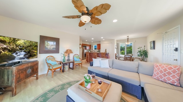 living area featuring recessed lighting, ceiling fan, and light wood-style flooring