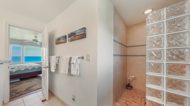 bathroom featuring tile patterned flooring, walk in shower, a ceiling fan, baseboards, and ensuite bath