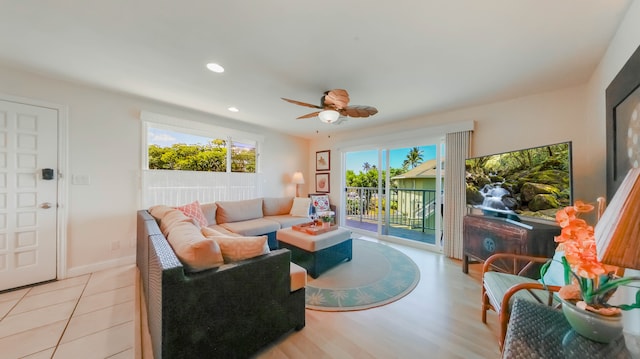 living room featuring baseboards, a ceiling fan, and recessed lighting