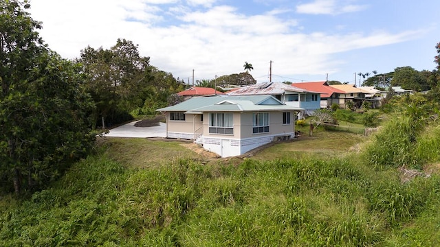 rear view of house featuring a yard