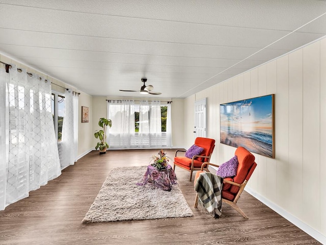 living area featuring wood finished floors and a ceiling fan