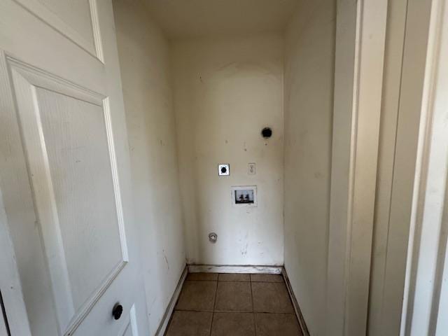 clothes washing area with hookup for a washing machine, hookup for an electric dryer, laundry area, dark tile patterned floors, and baseboards