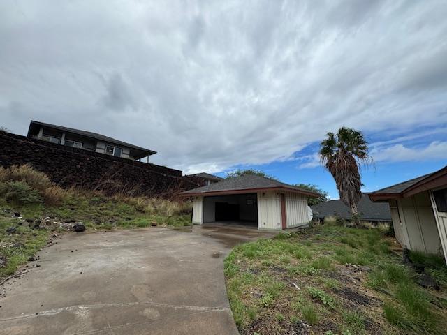 exterior space featuring a garage and an outdoor structure