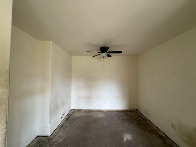 empty room featuring concrete flooring and a ceiling fan