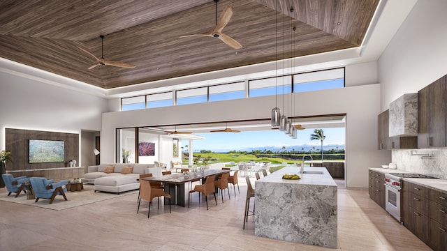 dining room featuring a tray ceiling, wooden ceiling, and ceiling fan