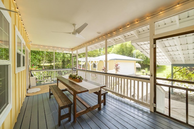 exterior space with ceiling fan, an outdoor structure, and outdoor dining space